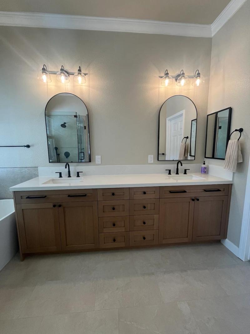 Complete bathroom renovation with marble tile work, frameless glass shower, and modern finishes in Roseville.